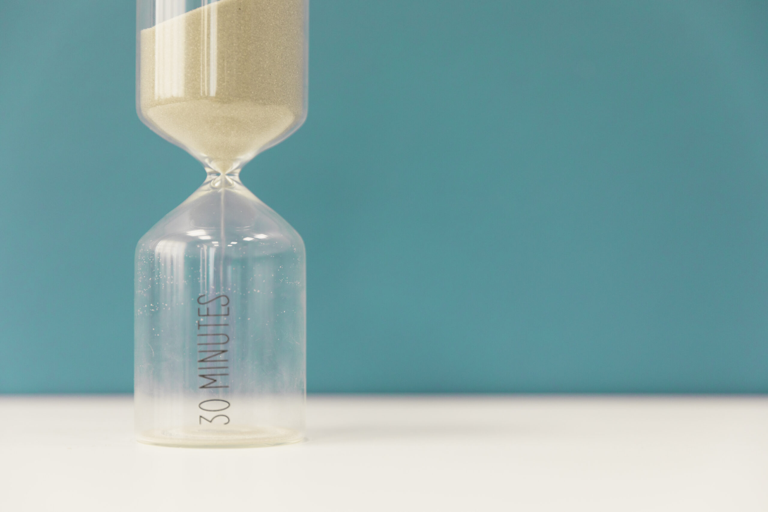 An hourglass in bluish background