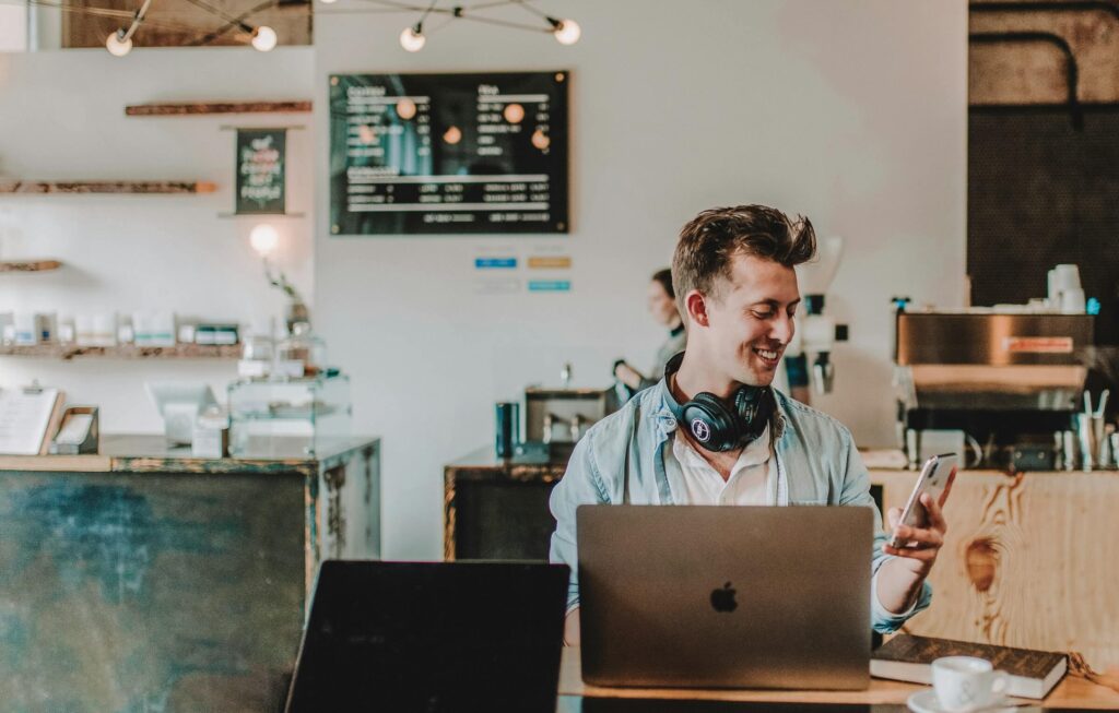 Balancing Personal Life and Business Responsibilities - a businessman enjoying his stay at a cafe while working
